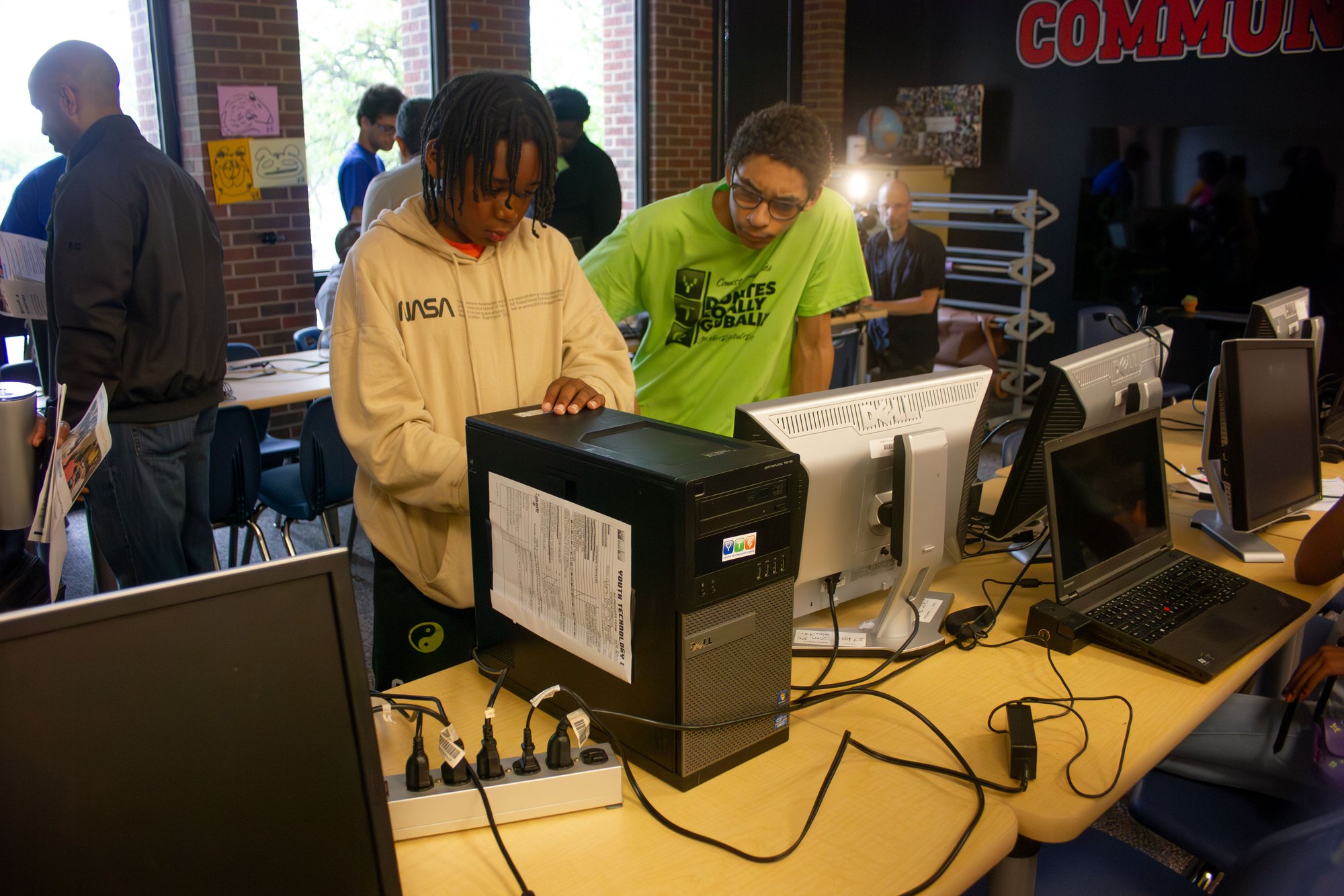 Two YTC students working together on a desktop tower in the clubroom